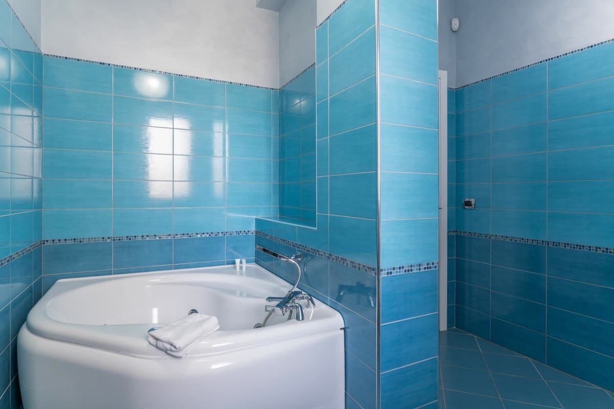 La vasca ad angolo del bagno blu, da vicino