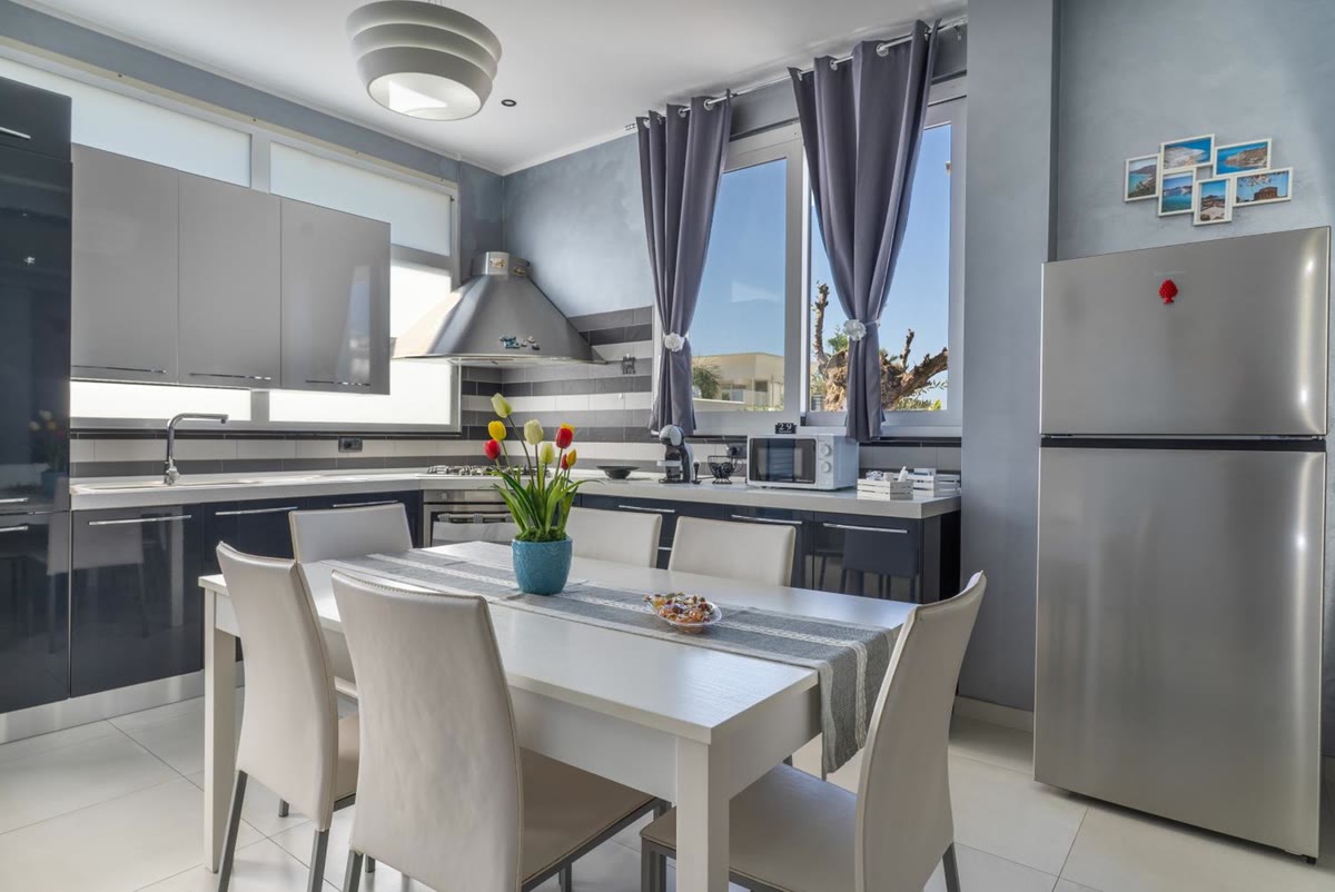 The kitchen: worktop, hood, fridge and table