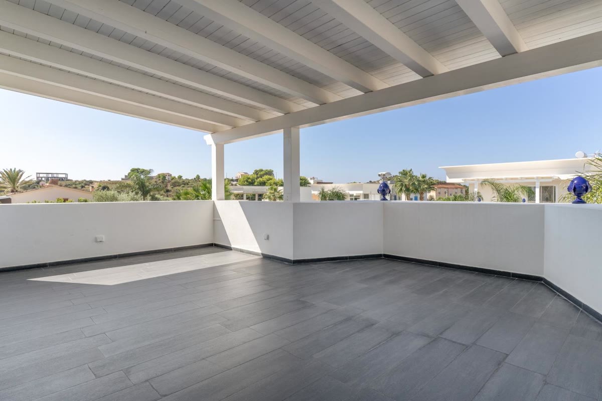 The covered veranda and the open sky beyond the parapet